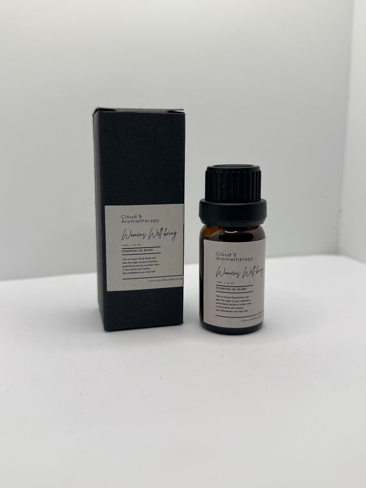 Single amber glass bottle labeled Women’s Well-Being essential oil blend on a soft background, highlighting handcrafted natural oils.