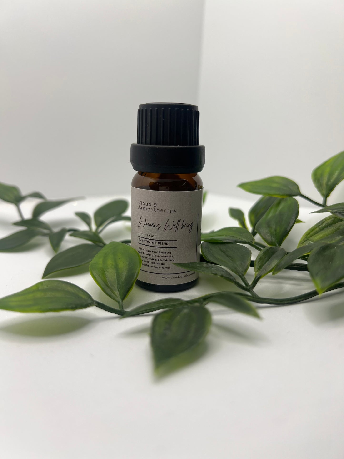 Women’s Well-Being essential oil blend in 10ml amber bottle with natural greenery, symbolising calming aromatherapy for women’s health.
