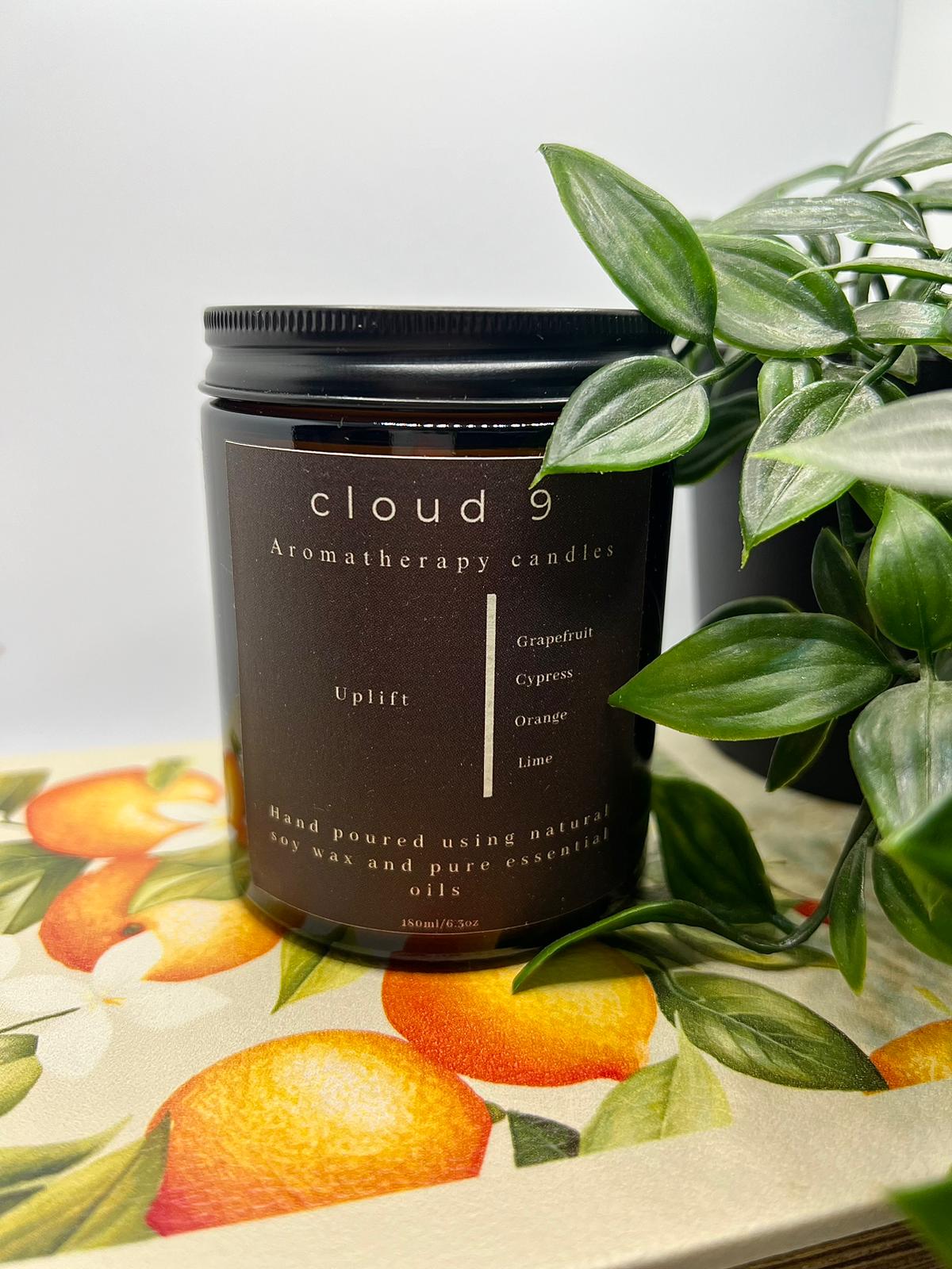 uplift soy candle with grapefruit, orange, cypress and lime essential oils in glass amber jar
