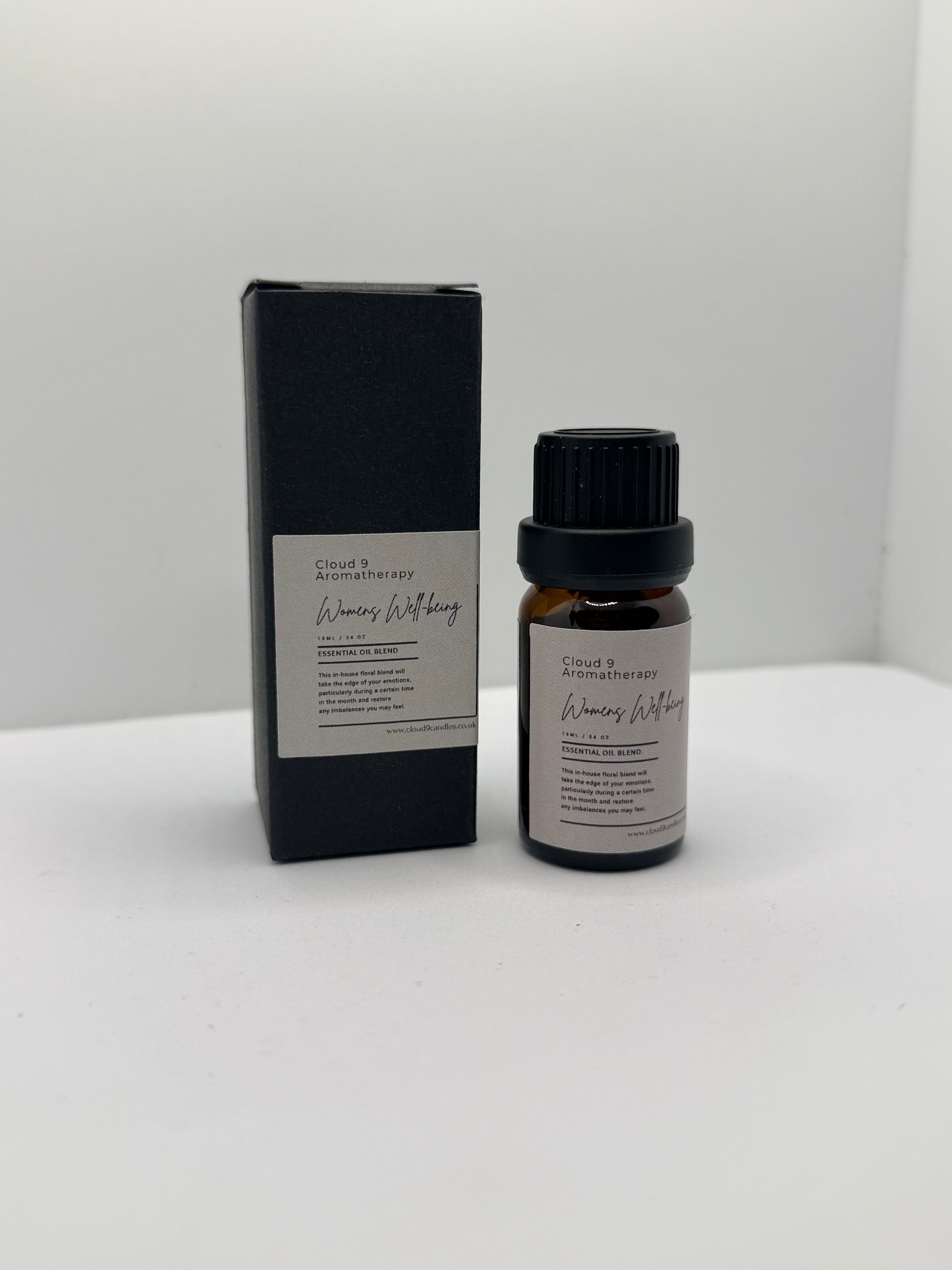 Single amber glass bottle labeled Women’s Well-Being essential oil blend on a soft background, highlighting handcrafted natural oils.