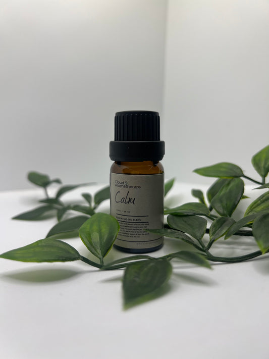 Amber 10 ml essential oil bottle labeled ‘Calm’ with sprigs of lavender and lemongrass, conveying natural relaxation.
