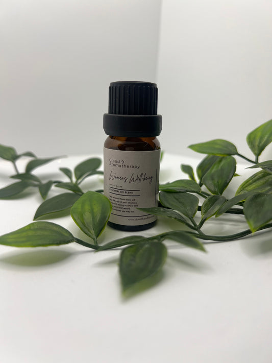 Women’s Well-Being essential oil blend in 10ml amber bottle with natural greenery, symbolising calming aromatherapy for women’s health.
