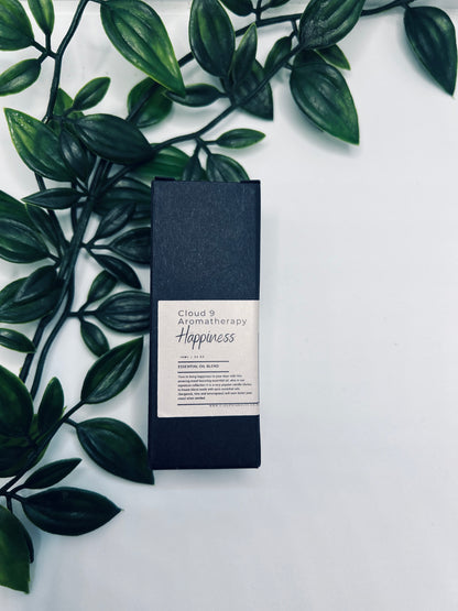 Boxed essential oil blend accompanied by greenery, hinting at premium presentation—could represent the Women’s Well-being or Calm blend in gift-ready packaging.