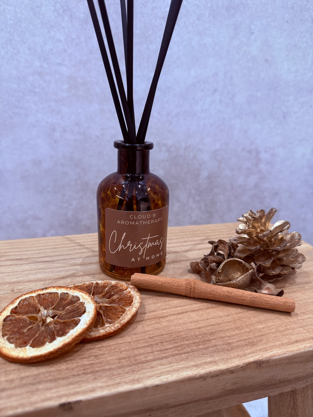 Christmas at Home reed diffuser styled in a cosy festive home by Cloud 9 Aromatherapy.
