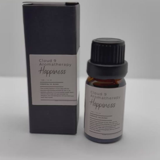 Two amber glass essential oil bottles nestled against greenery—elegant packaging for Cloud 9’s customizable 2-essential-oil–blends gift set.