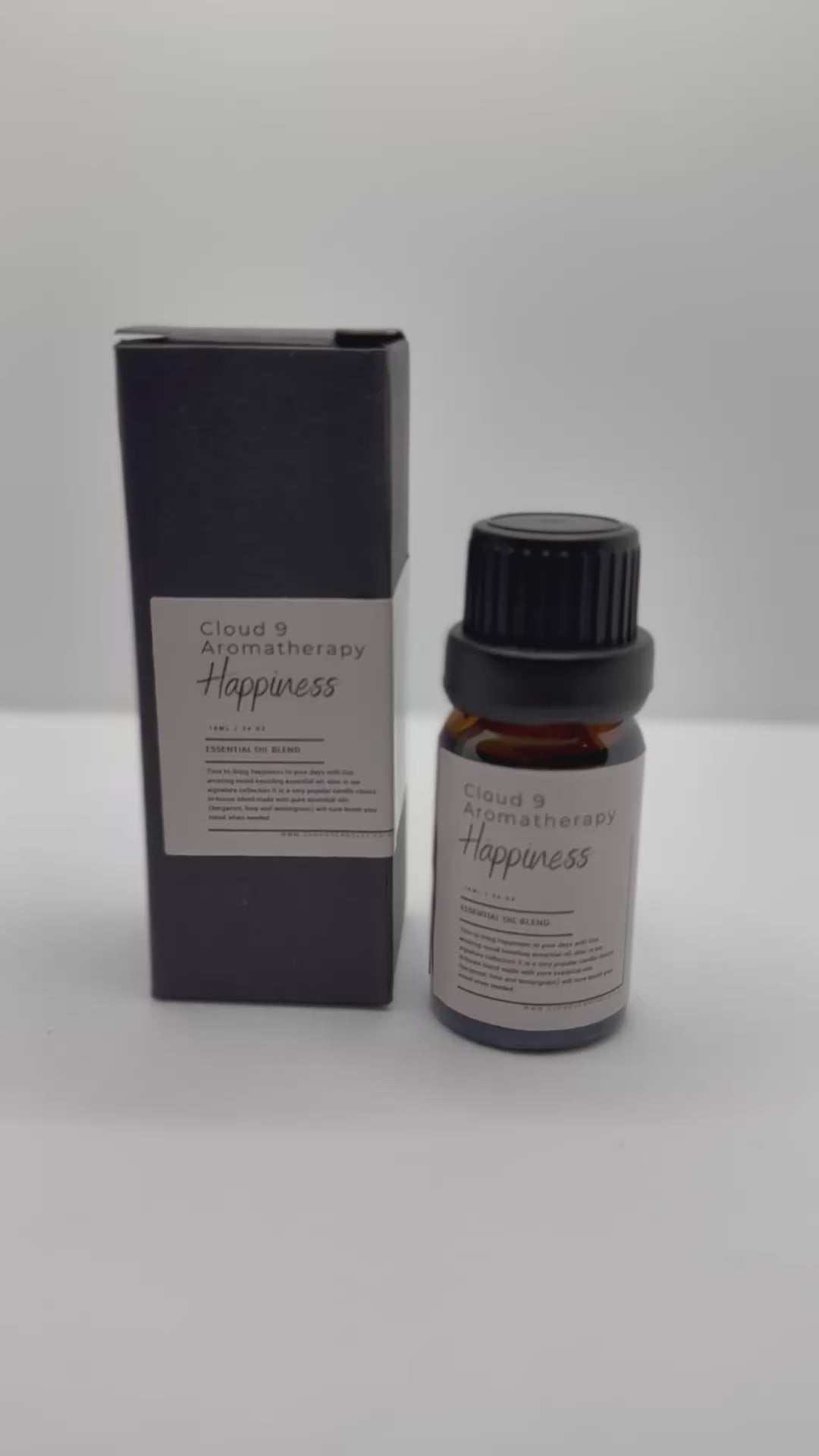 Two amber glass essential oil bottles nestled against greenery—elegant packaging for Cloud 9’s customizable 2-essential-oil–blends gift set.